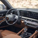 The interior of the 2023 Kia Telluride SX X-Pro, shown with caramel brown leather upholstery and a detailed view of the steering wheel and center console.